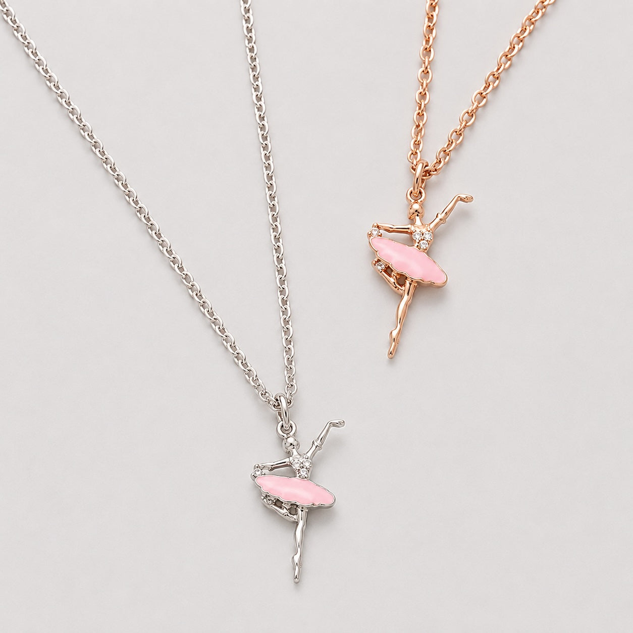 Silver and rose gold ballet dancer pendant necklaces with pink tutu detail and crystal accents for girls
