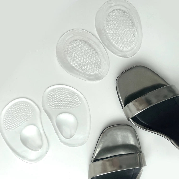 Two pairs of Barefoot Scientist So Jelly clear gel shoe cushions displayed beside silver shoes