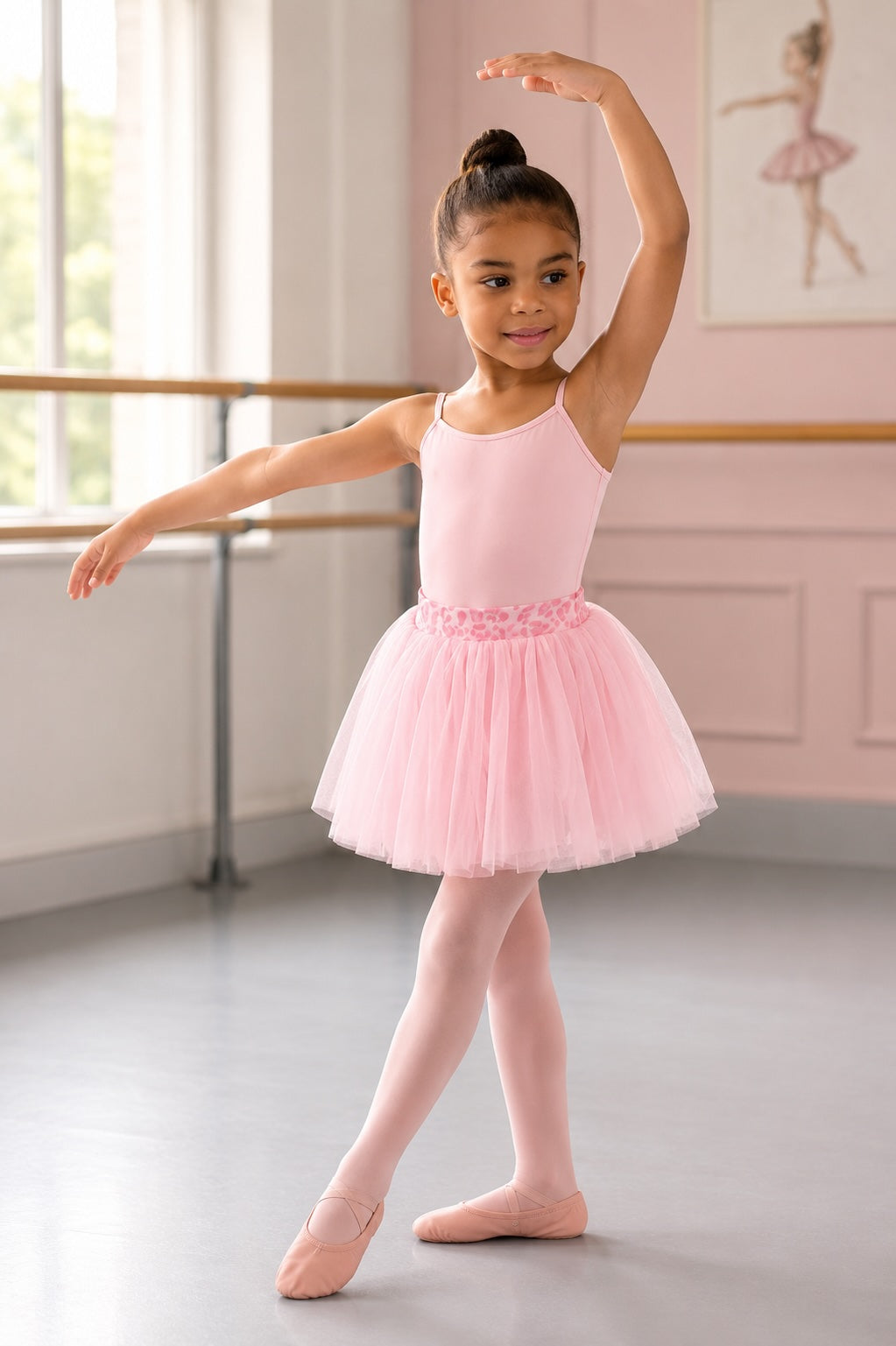 Girl wearing Bloch CR6521 Candy Pink tutu skirt with animal print waistband in a ballet studio