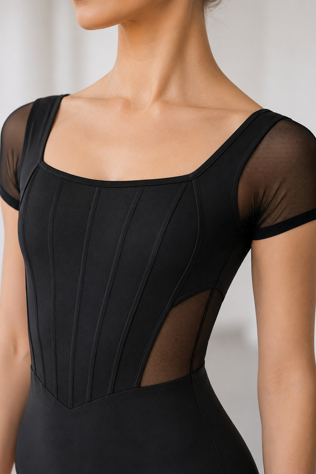 Bloch Mia L20011B black dance leotard close-up showing mesh sleeves and corset-style detail