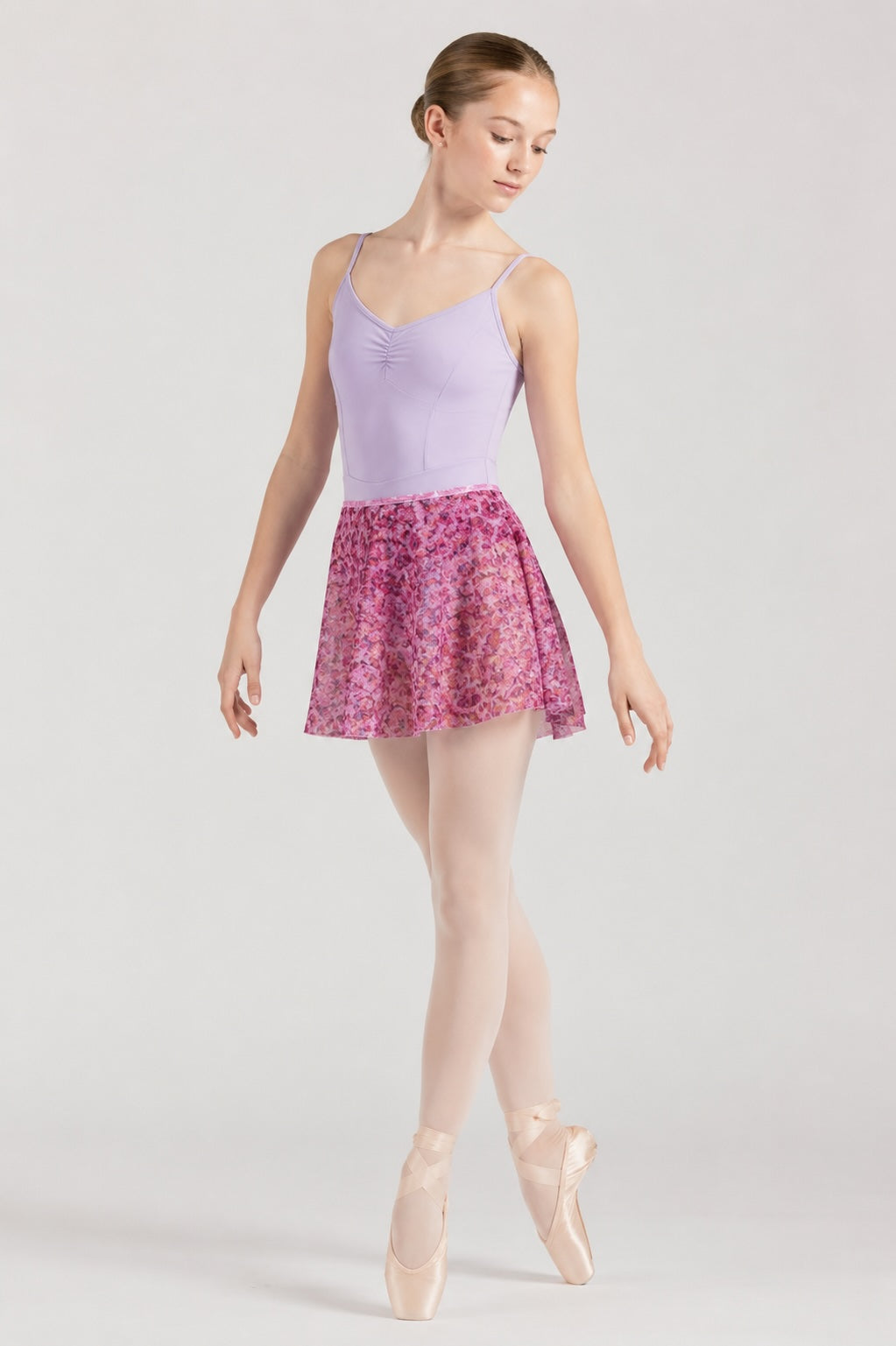 Dancer wearing Bloch R0241 Bell Flower floral ballet skirt with lilac leotard front view
