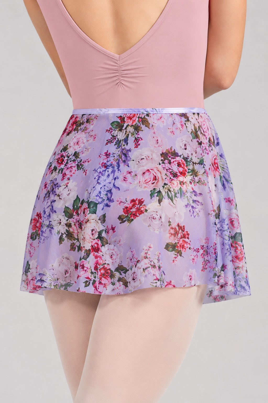 Close-up of Bloch R0241 Bouquet floral ballet skirt worn with dusty pink ballet leotard