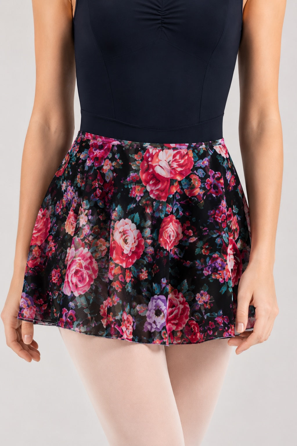 Close-up of Bloch R0241 Rose floral ballet skirt worn with navy ballet leotard