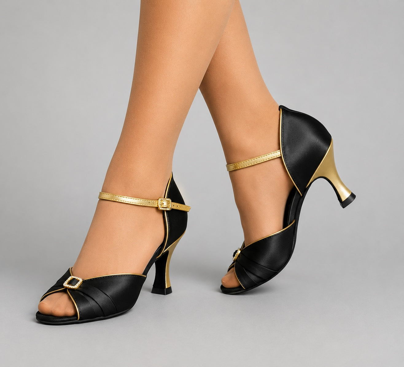 Bloch S0833SA black and gold ballroom dance shoes with diamante buckle detail, worn by a dancer.