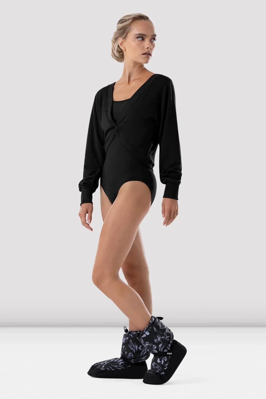 Pair of Bloch black floral warm-up booties with pink and white flowers, ankle straps and drawstring cuffs