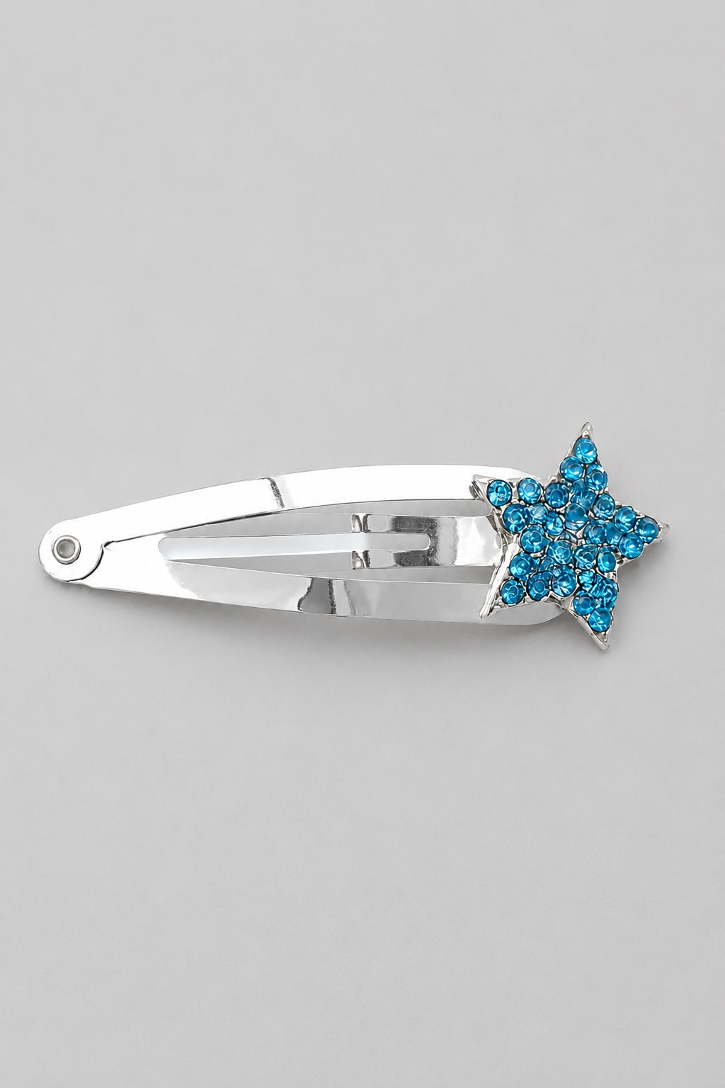 Blue sparkly star hair clip with silver clip detail on a light grey background by Molly & Rose