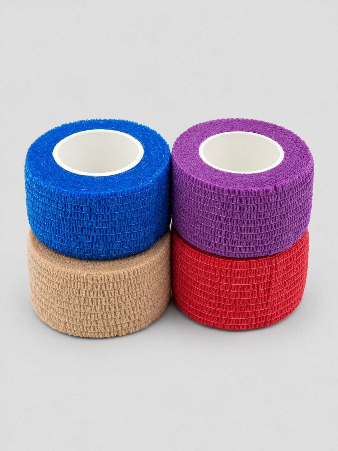 Bunheads Adhesive Toe Wrap Core Multi pack featuring four self-adhesive toe wraps in blue, purple, red and nude colours for pointe shoe protection and toe support.