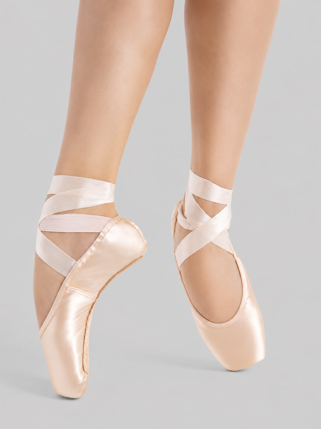 Close-up of Capezio Kylee Pointe Shoes 1140W worn en pointe in petal pink satin showing the platform and box shape