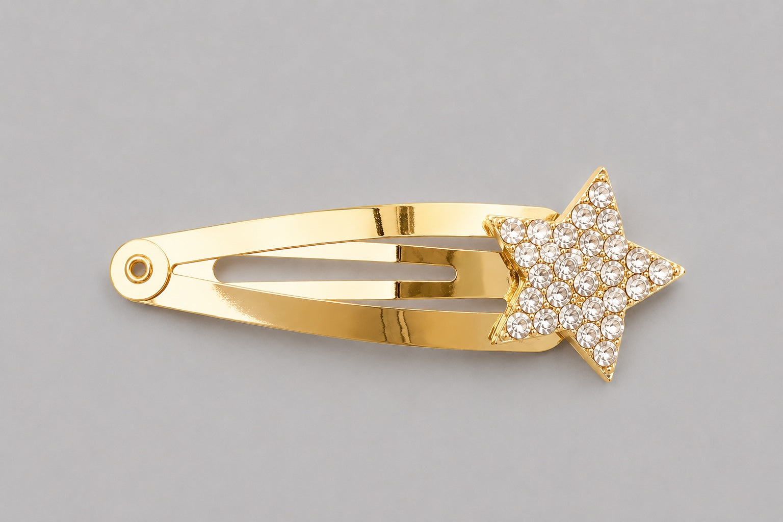 Clear crystal sparkly star hair clip with gold clip detail on a light grey background by Molly & Rose