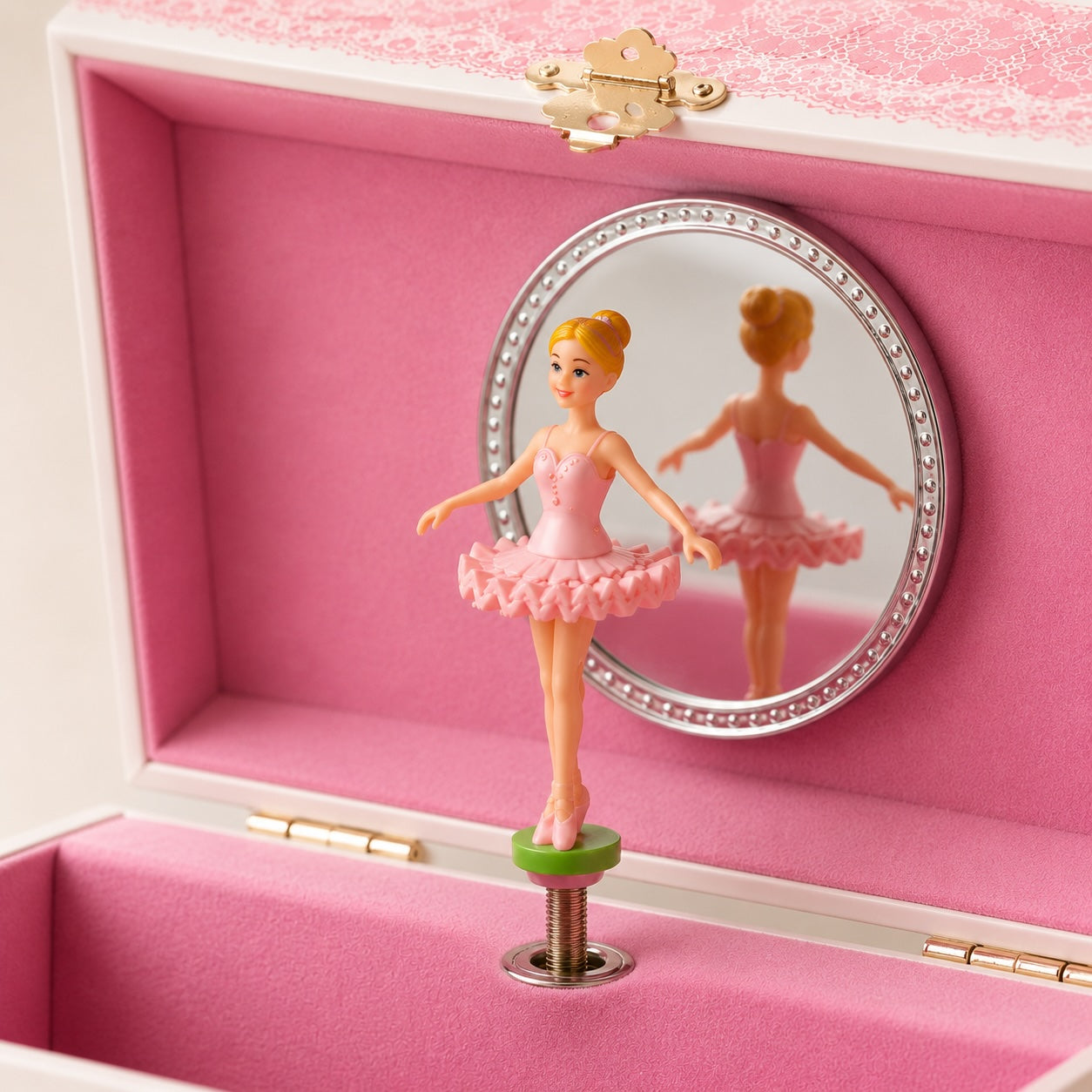 Close-up of spinning ballerina inside pink musical jewellery box with mirror