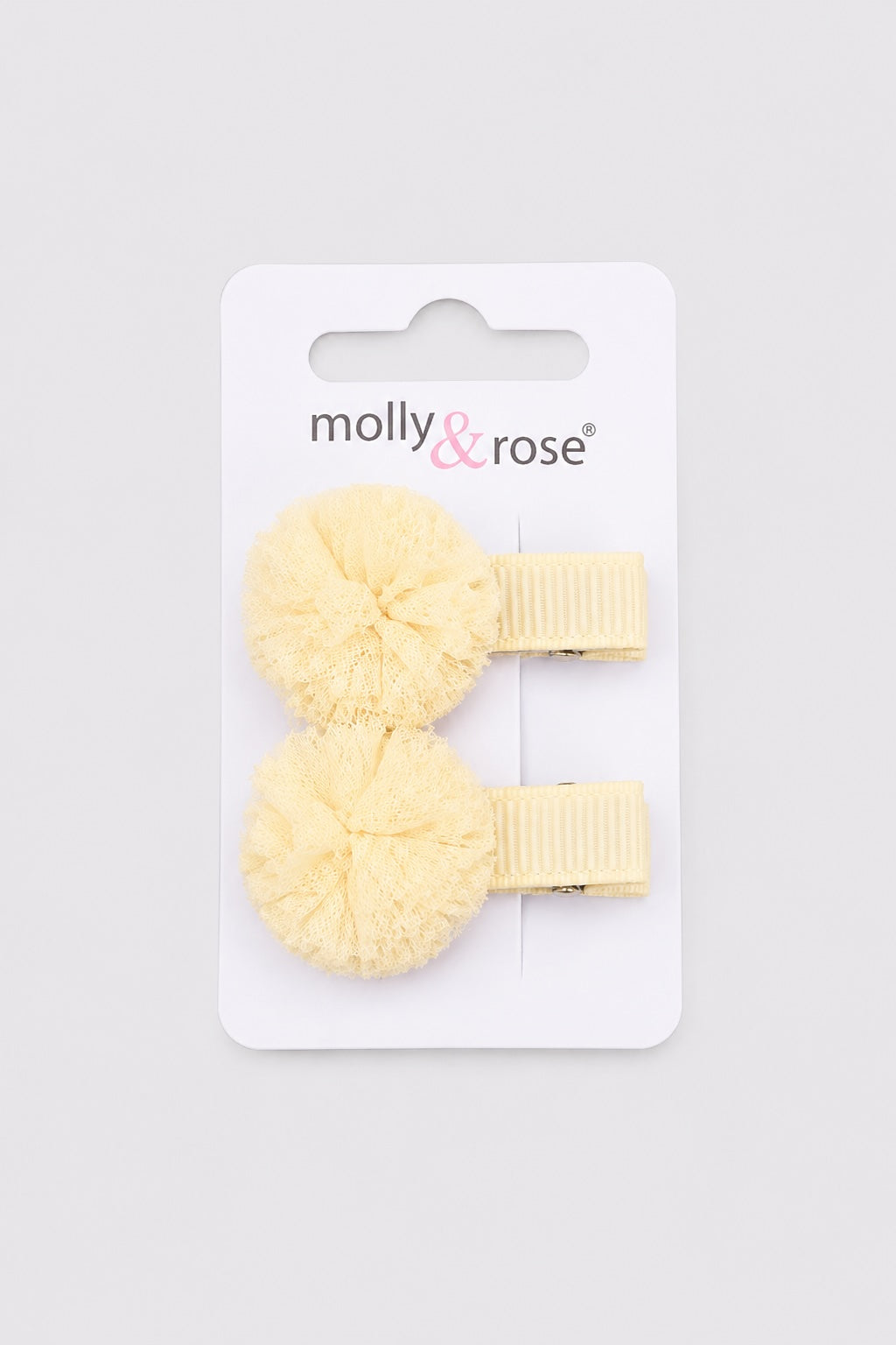 Cream pom pom hair clips for little dancers by Molly & Rose on light grey background