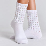 Model wearing white Irish dancing diamante poodle socks with textured bubble cuffs against a light grey background.