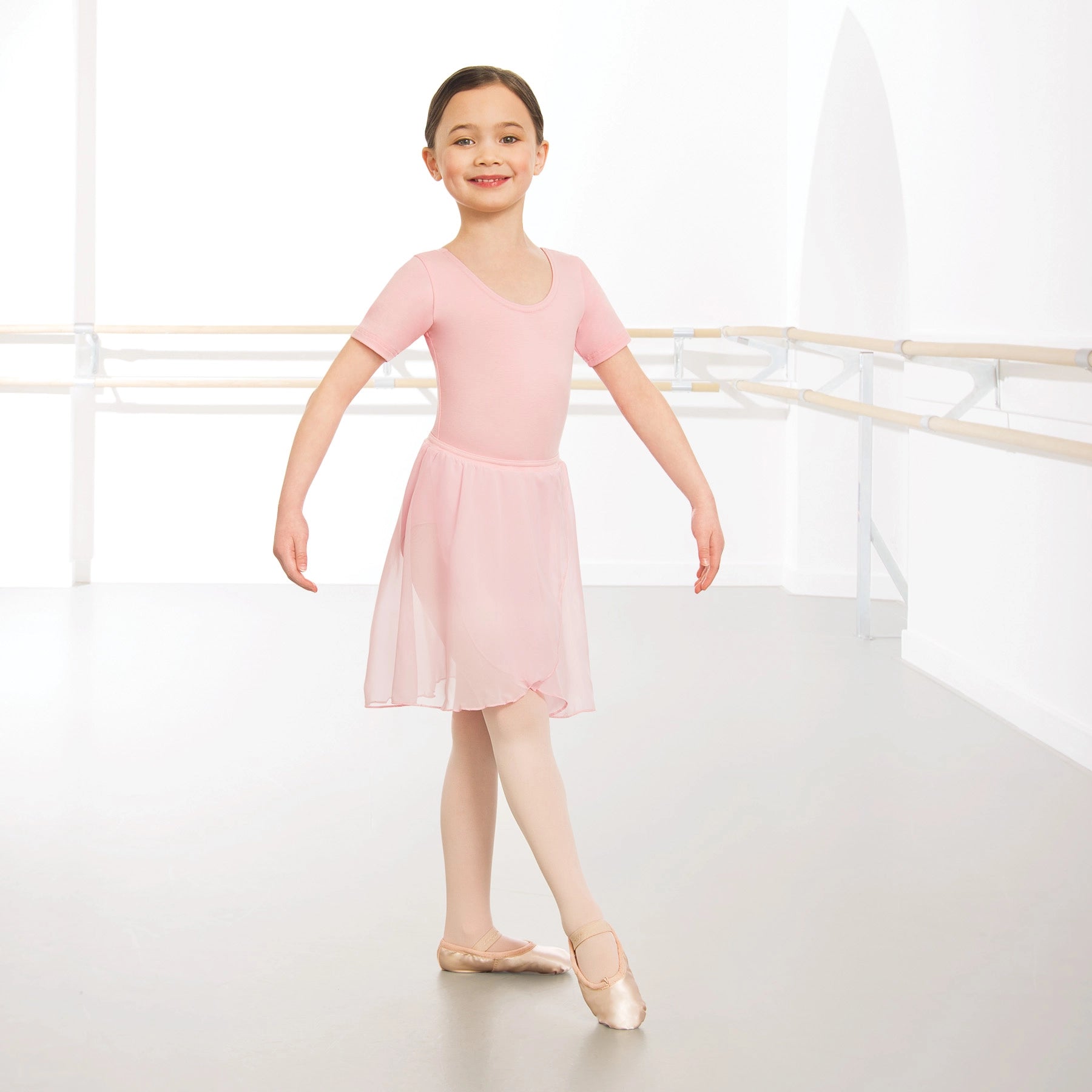 Pink chiffon ballet wrap skirt girls front view worn over leotard elastic waistband