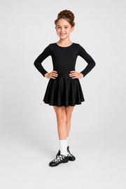 Young Irish dancer wearing black first feis skirt with long sleeve leotard and Irish dancing shoes