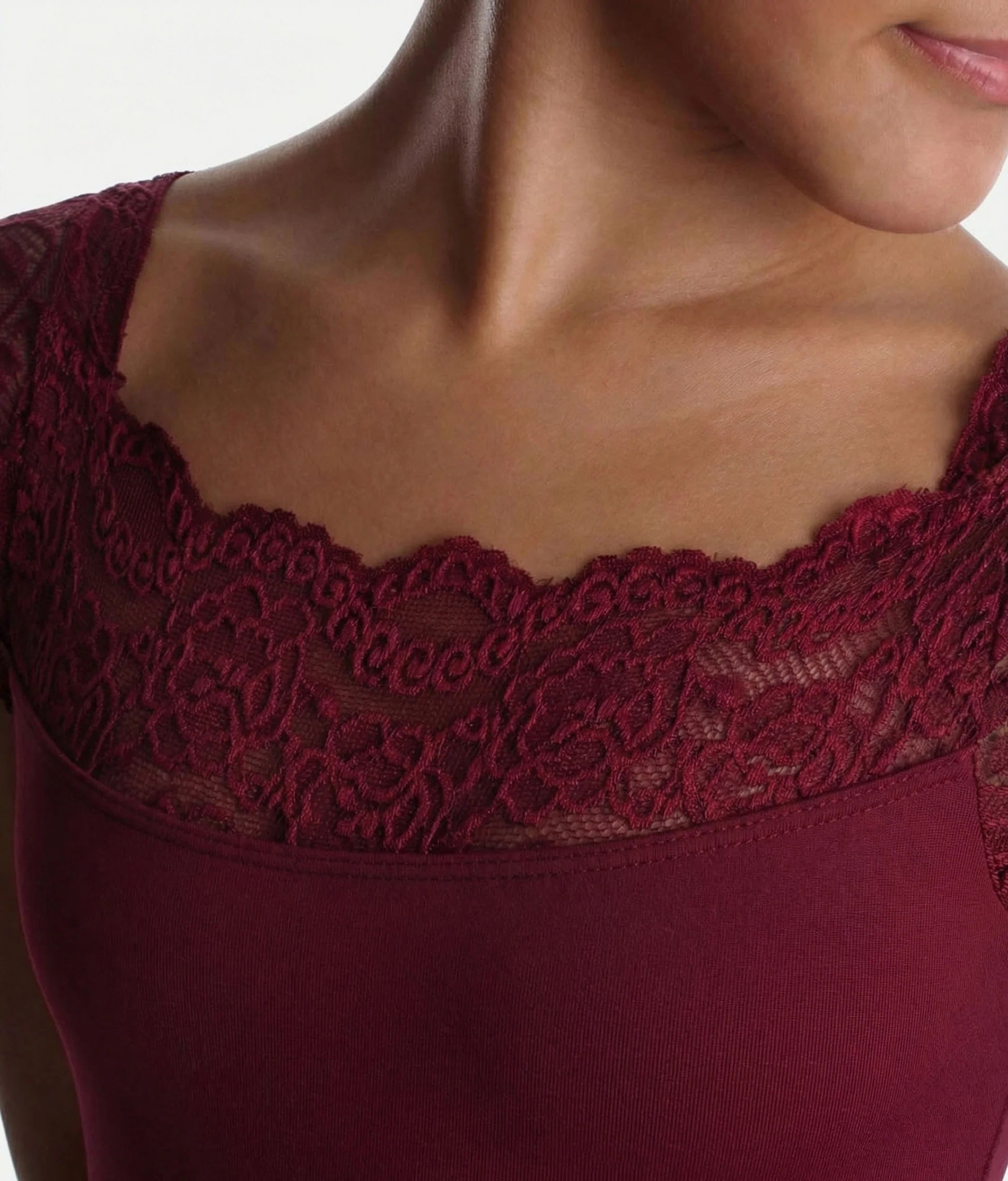 Alt text: Close up of lace neckline and sleeves on burgundy So Danca SL17 girls leotard