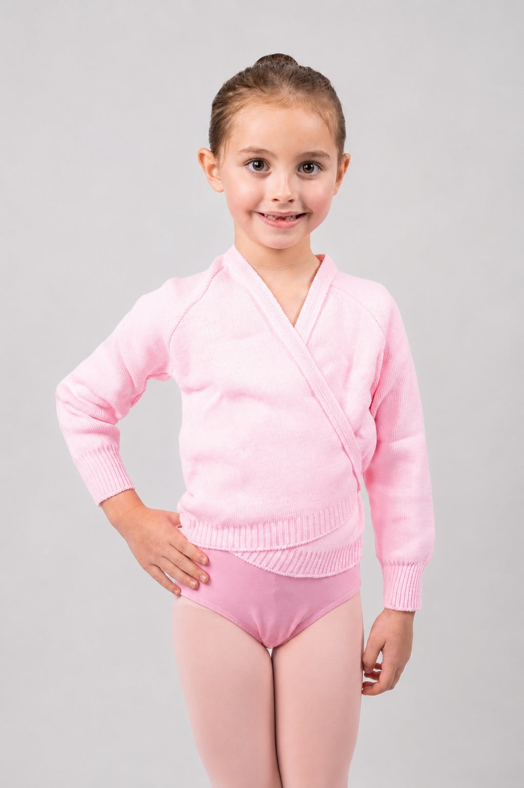 Girl wearing pink Pulsara ballet wrap cardigan – front view.