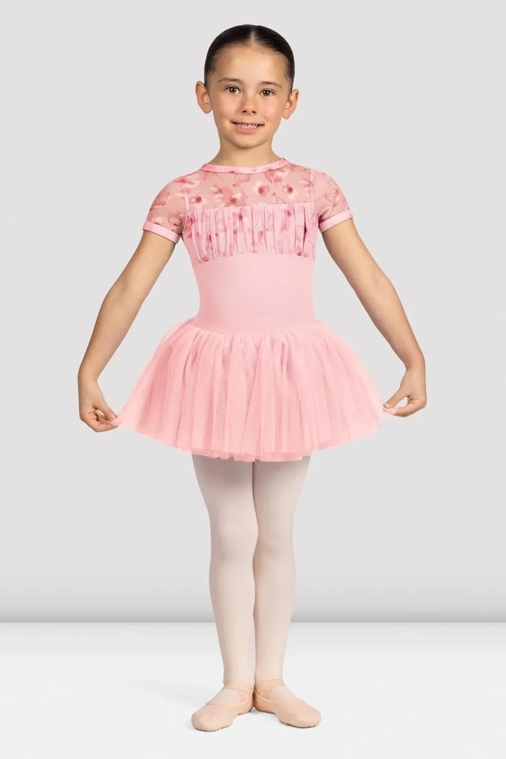 Girl wearing Bloch CL4282 pink floral ballet tutu dress with floral mesh bodice and layered tulle skirt