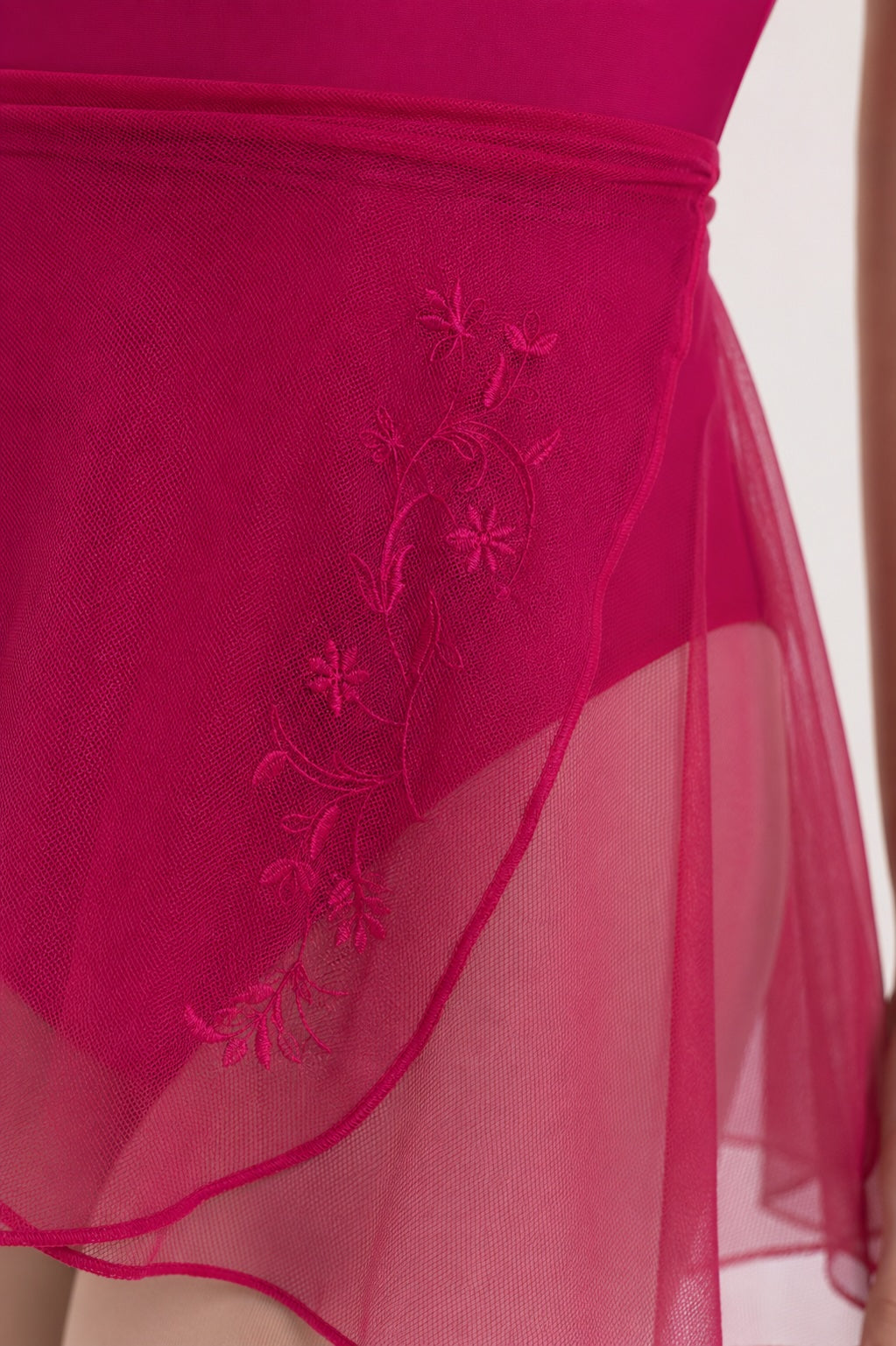 Close up of floral embroidery detail on Intermezzo magenta ballet wrap skirt