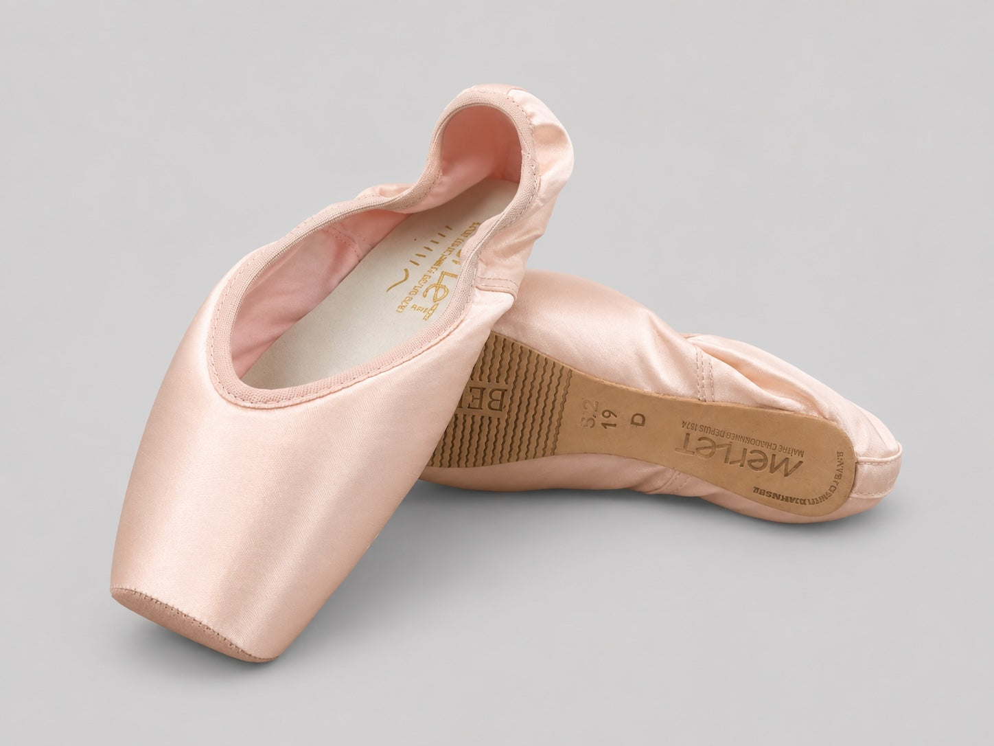 Merlet Belle pointe shoes displayed on light grey background showing platform and sole view