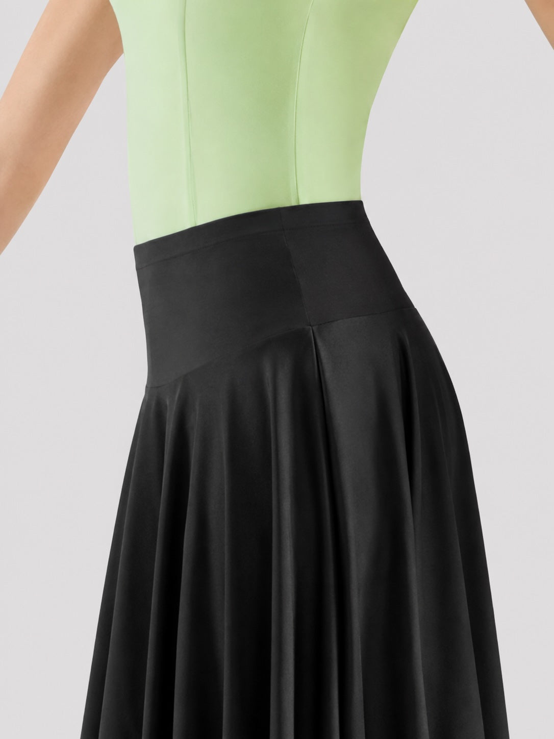 Close-up of Mirella MS23 black ballroom dance skirt showing the wide smooth waistband and flowing full-circle fabric.