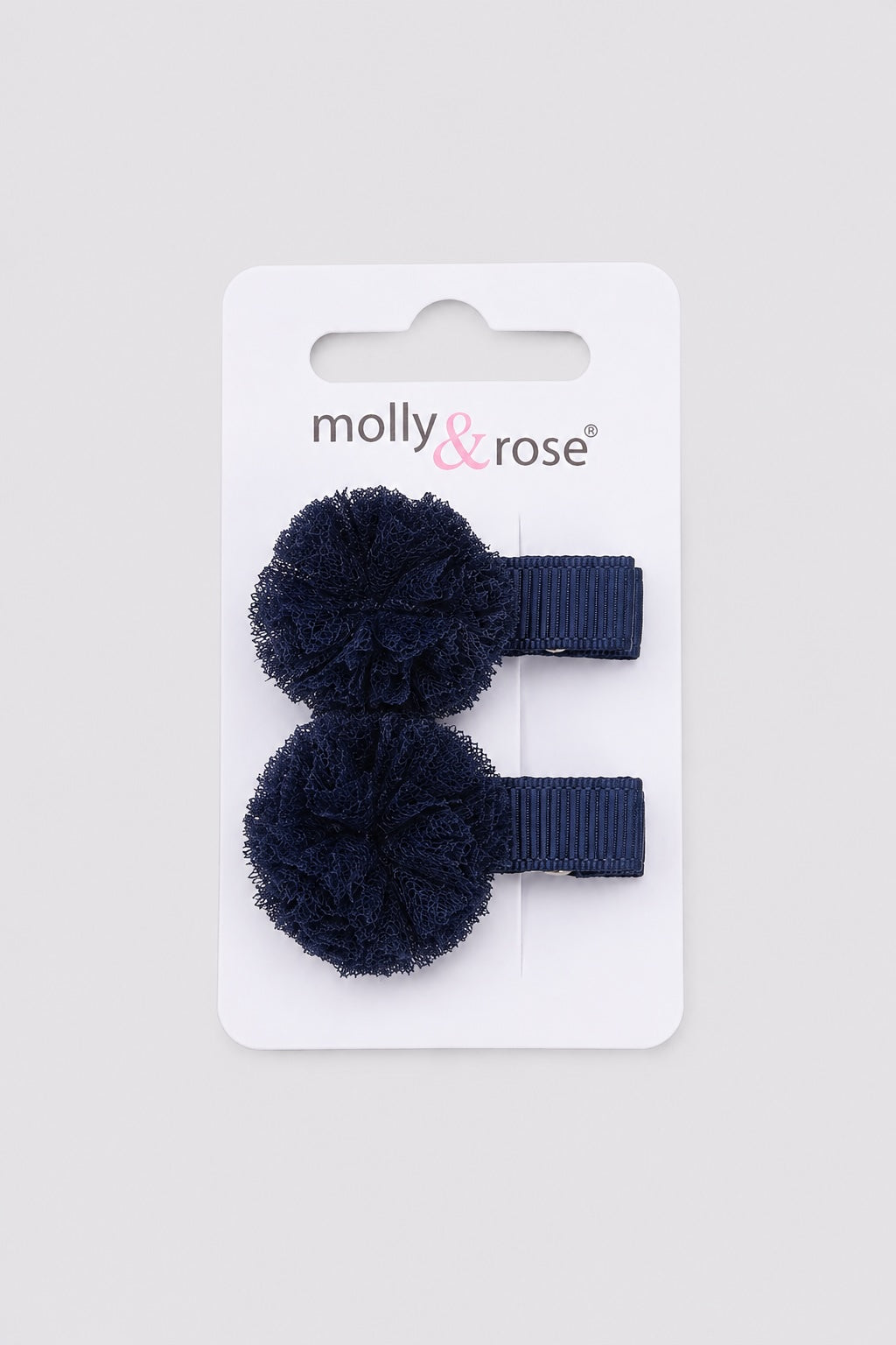 Navy pom pom hair clips for little dancers by Molly & Rose on light grey background