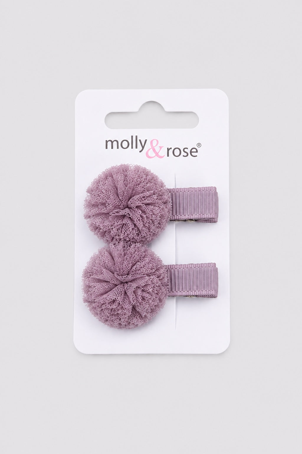 Purple pom pom hair clip with textured fabric flower on a light grey background for dancers and girls hair accessories