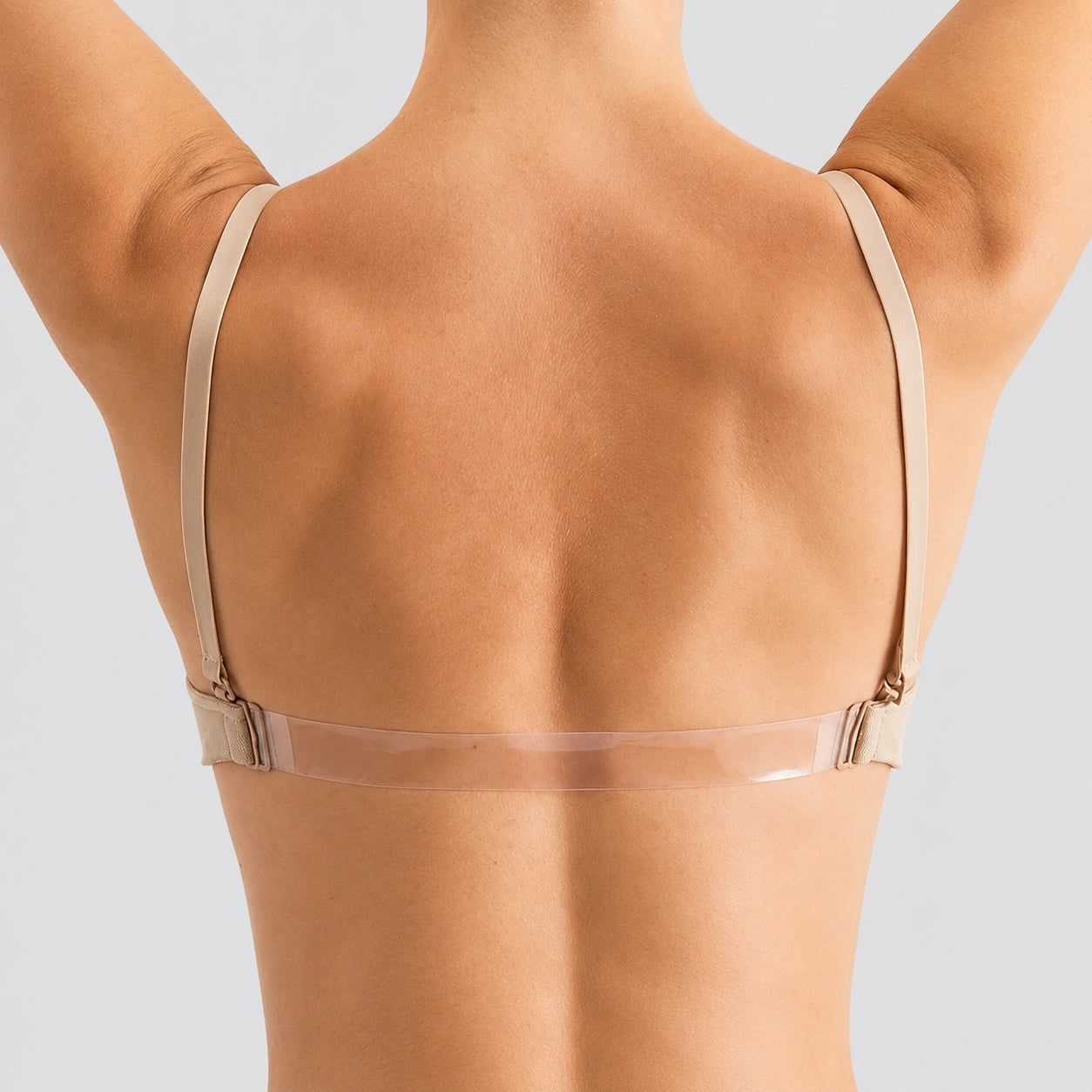 Back view of Silky Dance seamless clear back dance bra in nude showing transparent back strap and adjustable shoulder straps