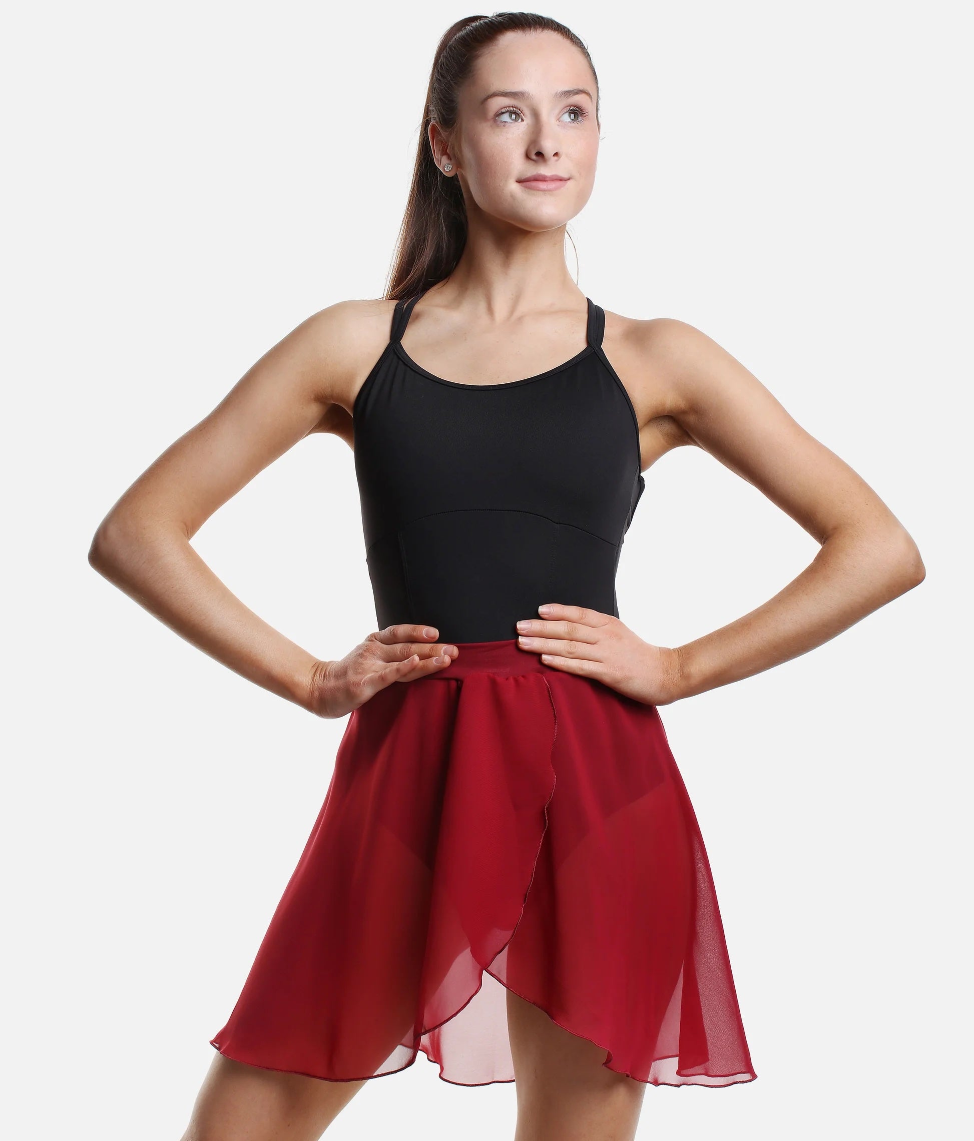 Dancer wearing burgundy So Danca SL93 pull-on faux wrap ballet skirt hands on hips