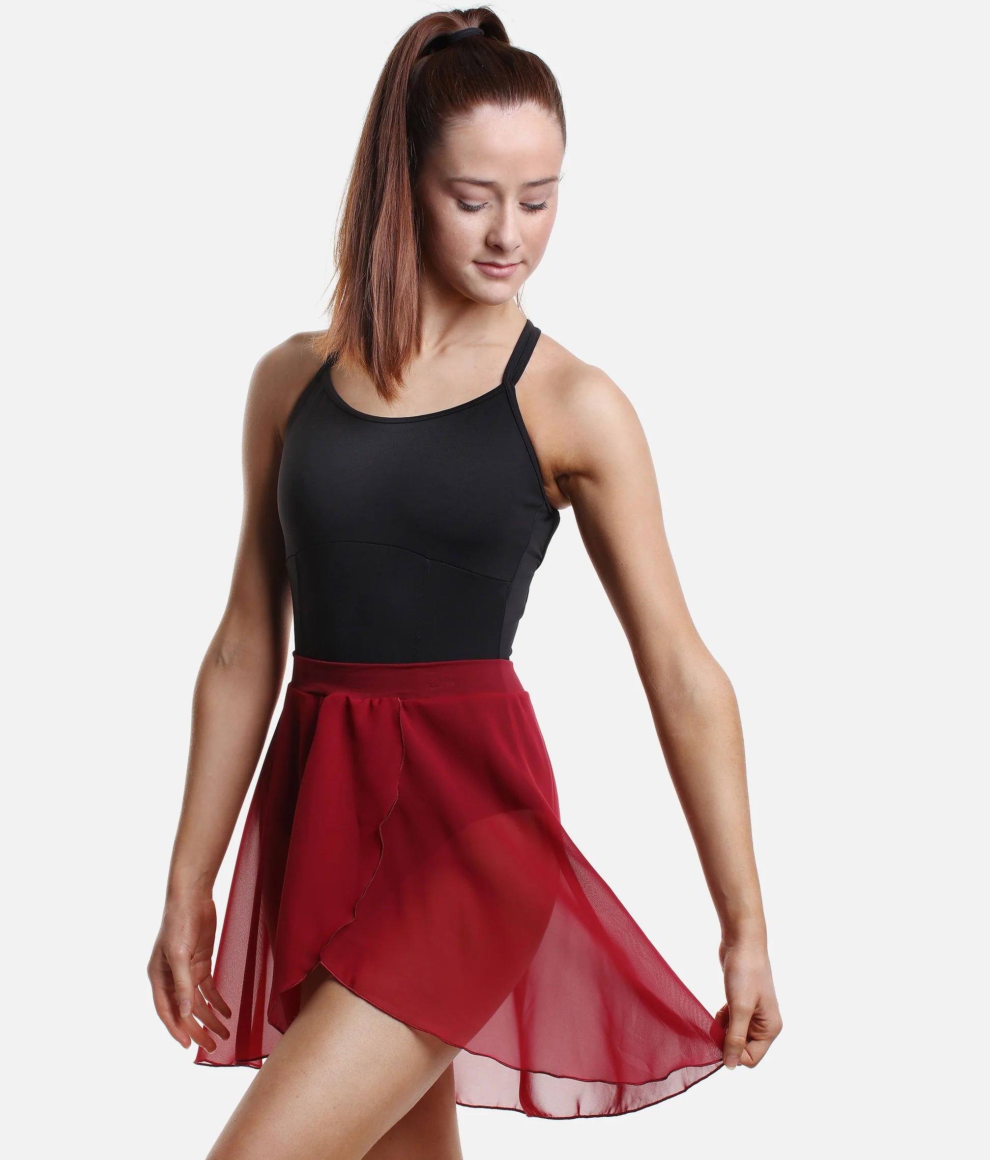 Dancer wearing burgundy So Danca SL93 faux wrap ballet skirt holding skirt side pose