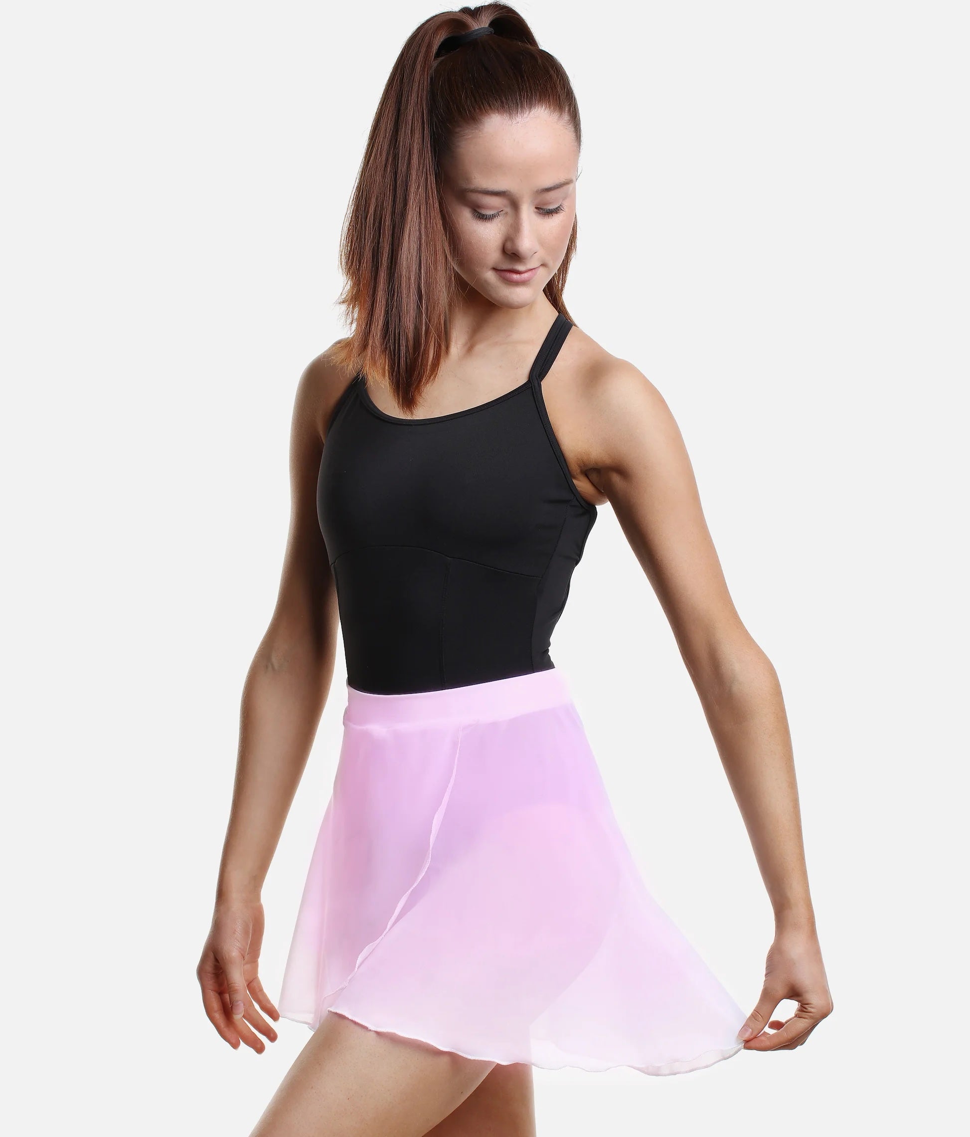 Dancer wearing light pink So Danca SL93 faux wrap ballet skirt holding skirt side pose