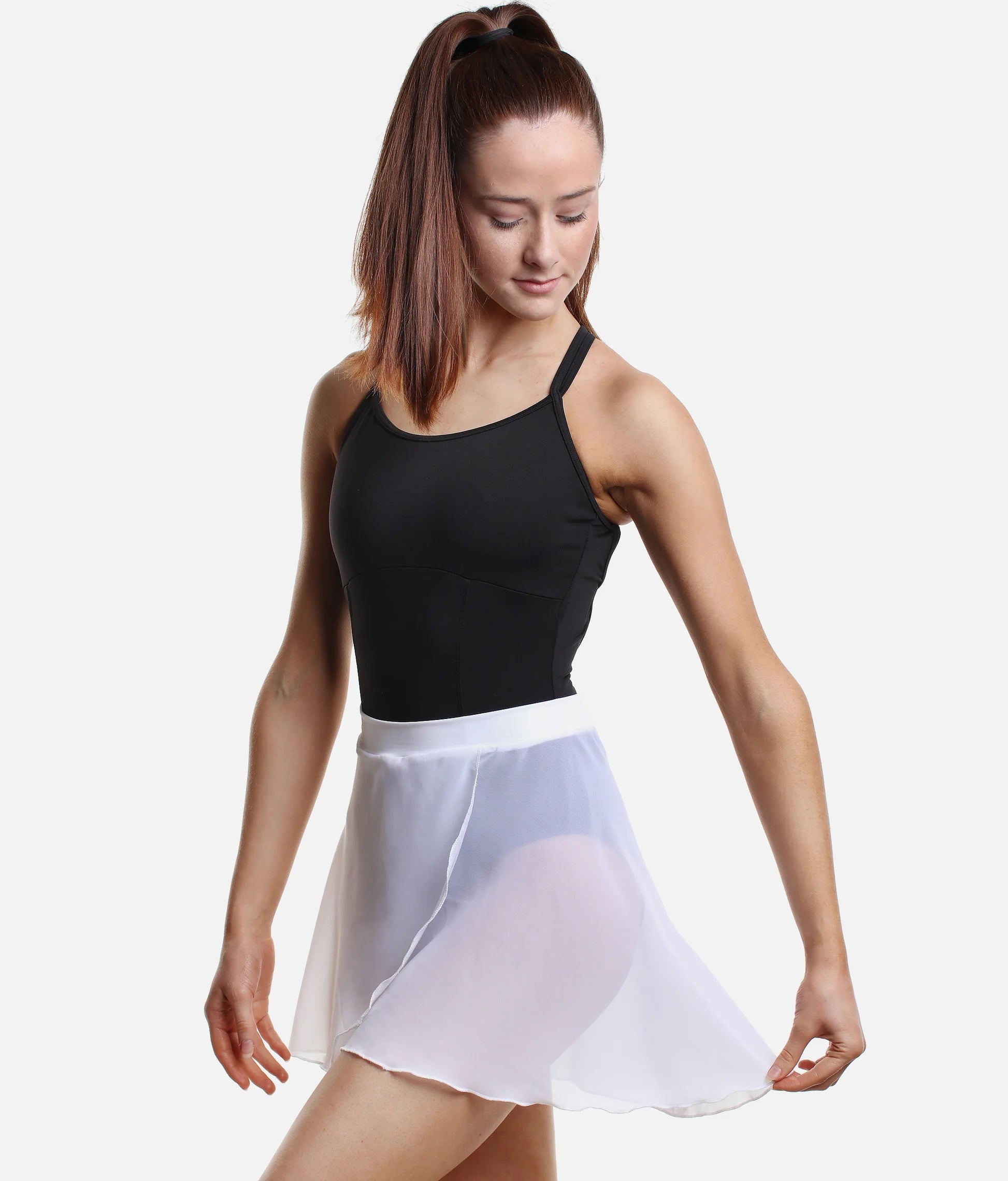 Dancer wearing white So Danca SL93 faux wrap ballet skirt holding skirt side pose