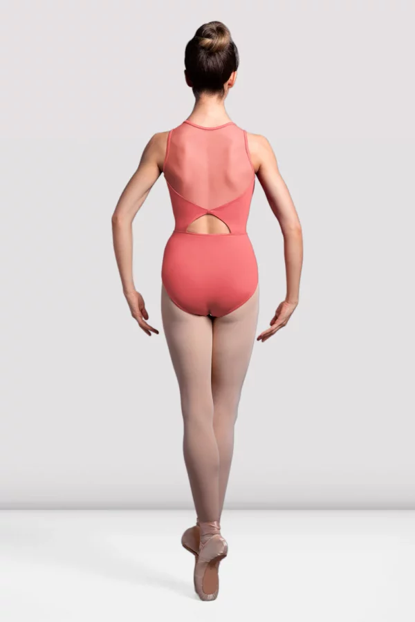 a woman in a leotard and ballet shoes, ballerina wearing a bloch leotard in coral colour