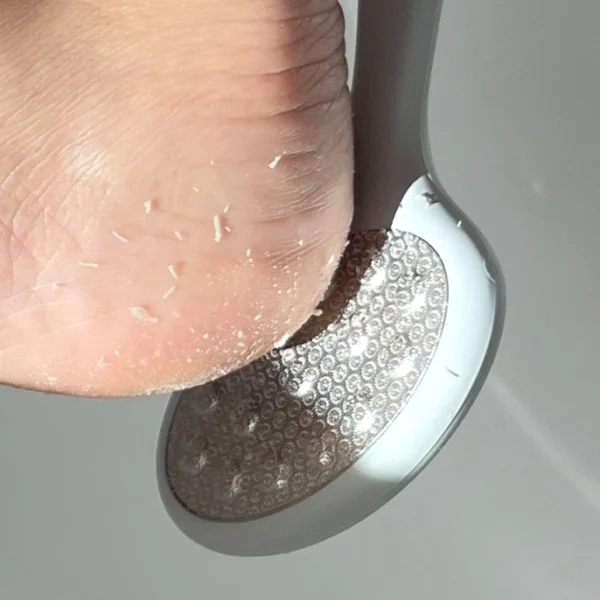 "Barefoot Scientist Smooth Things Over stainless steel foot file" "Double-sided pedicure file for exfoliating and smoothing feet" "Smooth Things Over foot file with ergonomic handle" "Premium stainless steel foot file by Barefoot Scientist" "Close-up of double-sided foot file showing gritty and flat surfaces" "Textured exfoliating side of Smooth Things Over pedicure tool" "Foot file surface detail for callus removal and skin smoothing"