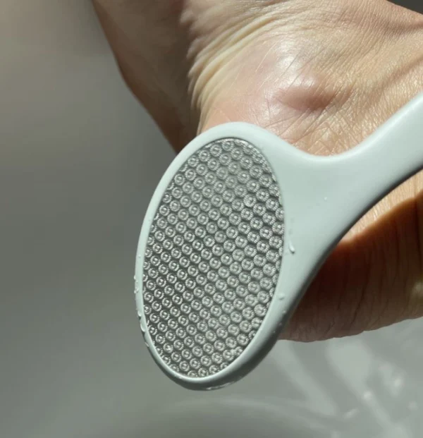 "Close-up of double-sided foot file showing gritty and flat surfaces" "Textured exfoliating side of Smooth Things Over pedicure tool" "Foot file surface detail for callus removal and skin smoothing"